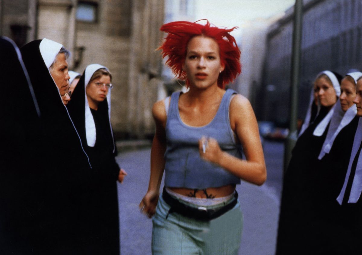 <p>On its surface, the German film <em>Run Lola Run</em> is about a blazingly red-headed woman running through the streets of Berlin in an attempt to save her boyfriend’s life. However, the twist is that once Lola reaches a dead-end (sometimes literally) in one of her runs, the film starts over from the beginning and Lola runs through Berlin once again, only this time small changes in her path create largely divergent outcomes by the film’s end. Although time is more of a thematic device than a strictly plot-driven one in Run Lola Run, its ruminations on time and the exploration of the <a href="https://www.americanscientist.org/article/understanding-the-butterfly-effect">Butterfly Effect</a>, the idea that small incidents can have lasting repercussions, makes <em>Run Lola Run</em> one of the most unique films on this list.</p>