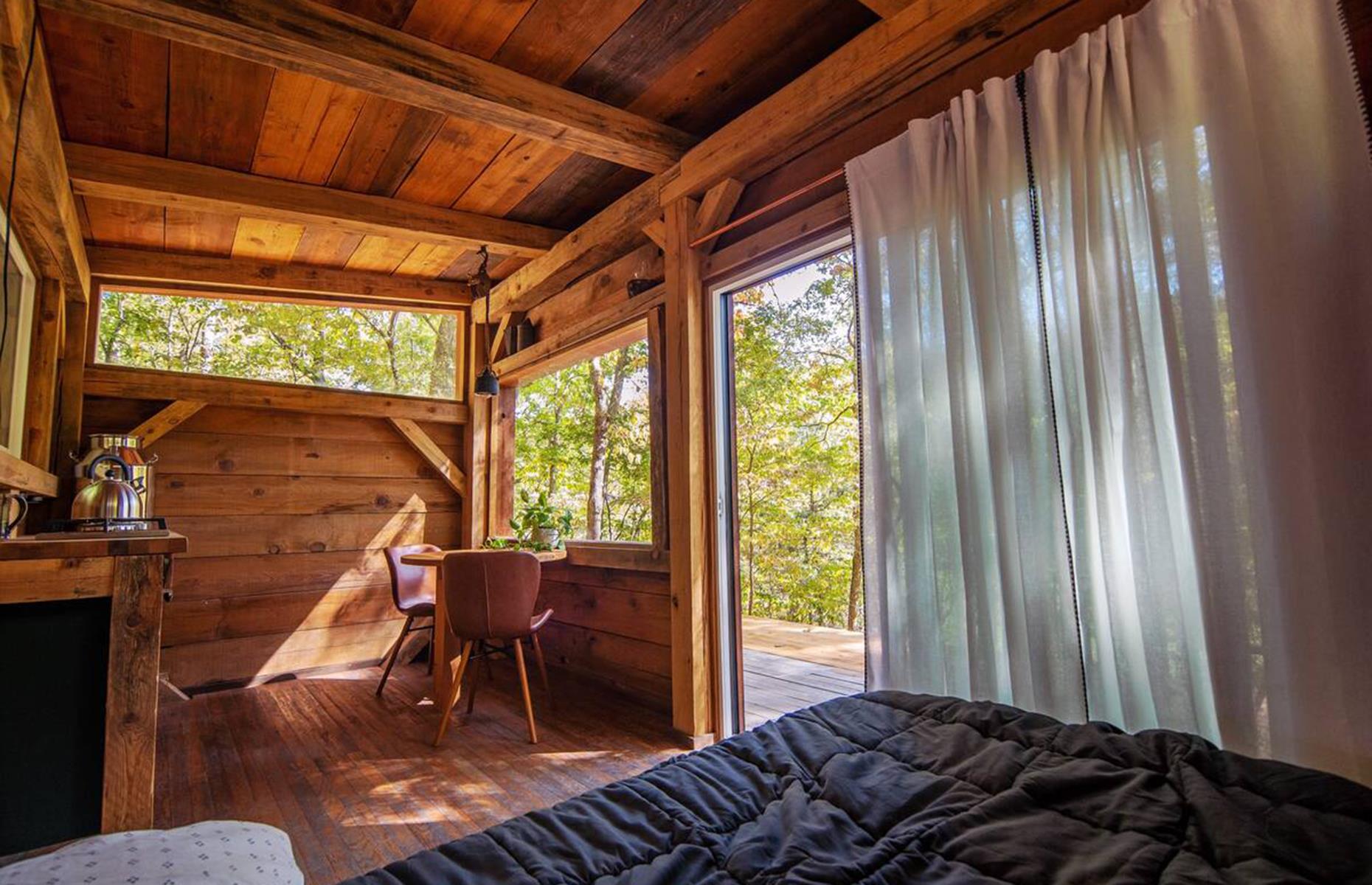 <p>Escape to the wilderness with <a href="https://www.airbnb.co.uk/rooms/584923908402382350?adults=2&check_in=2023-02-15&source_impression_id=p3_1671541021_UvSy2R9XpUG%2FOdyF&guests=1&check_out=2023-02-16">this rustic tiny home</a>, which was hand-built on the outskirts of Huntsville, a city known for its somber Civil War history. Ideal for nature lovers, the off-grid cabin is perched beside a spring-fed creek and surrounded by hiking and biking trails. It's powered by solar panels, with a propane cooktop, small fridge and basic cooking utensils, plus a bed surrounded by windows onto the wild. It'll set you back $99 per night. </p>