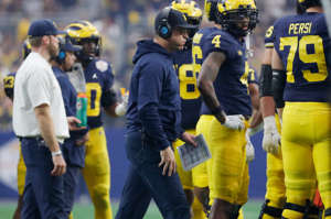 Michigan head coach Jim Harbaugh exhales on the sidelines during the first quarter against TCU of the Fiesta Bowl on Saturday, Dec. 31 at State Farm Stadium in Glendale, Ariz.