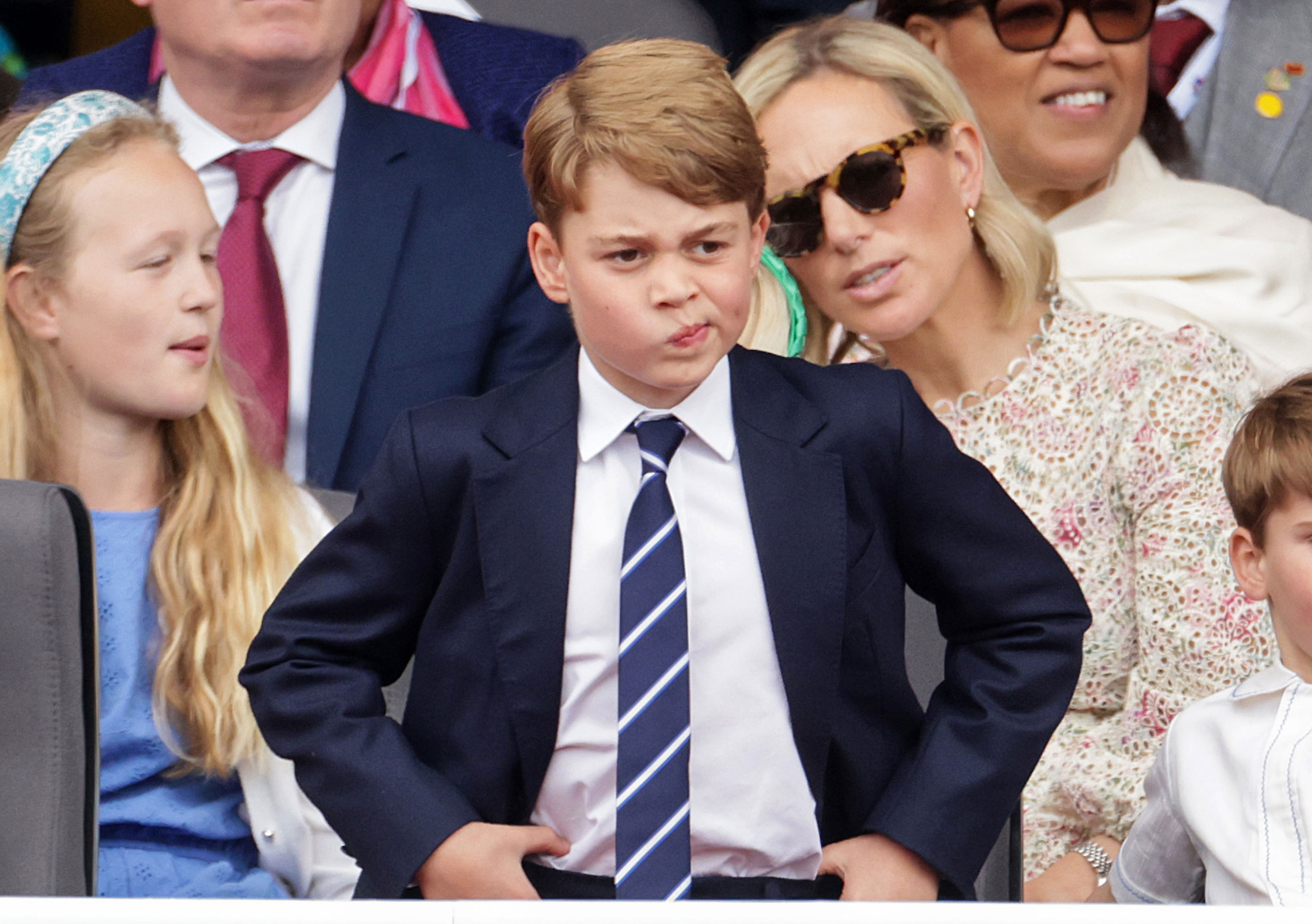 <p>Prince George pondered his feelings while watching the Platinum Pageant in London, the final event celebrating Queen Elizabeth II's <a href="https://www.wonderwall.com/celebrity/royals/platinum-jubilee-see-the-best-photos-from-4-days-of-celebrations-marking-the-queens-70-year-reign-606239.gallery">Platinum Jubilee marking 70 years on the throne</a>, on June 5, 2022. Cousins Savannah Phillips and Zara Tindall sat in the row behind him.</p>