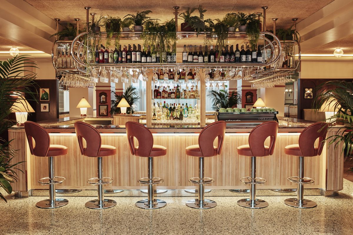 <p><strong>The bar:</strong> To the right of the lobby and directly in front of the entrance sits an open bar decorated in a mix of mid-century and 1970s furniture in hues of cream, burnt orange/dusty pink and dark brown that have us transported straight to Miami Beach if only in spirit. Bar stools line the marble-topped bar, with fauna spilling over from shelves above and around the more plush seating areas to the side. The lychee Martini is a must – expect to see staff wandering around with trays full of the deliciously fresh tipple from noon to midnight given its popularity.</p>