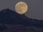 The full moon rises near the summit of Mount Diablo before the lighting of the beacon as photographed from Moraga, Calif., on Wednesday, Dec. 7, 2022. Tonight's full moon is also called the Cold Moon. The lighting of the beacon pays tribute to the lives that were lost at Pearl Harbor and also honors the surviving veterans of that day. (Jose Carlos Fajardo/) ORG XMIT: CAJOS601