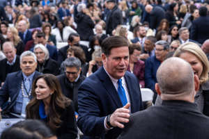 Former Arizona governor Doug Ducey greets attendees during the public ceremonial inauguration for newly elected Arizona officials at the State Capitol Mall on Jan. 5, 2023, in Phoenix.