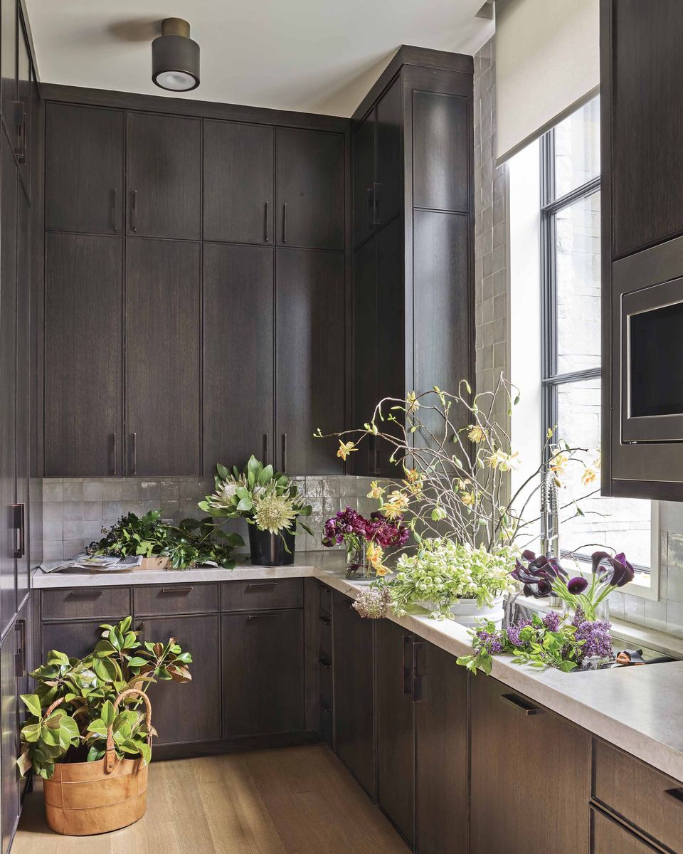 <p>In this "back kitchen" at a <a href="https://www.veranda.com/decorating-ideas/house-tours/a35369884/mcbrearty-dallas-house-tour-march-2021/">Dallas home designed by Meredith McBrearty</a>, ebonized cabinetry and bronze hardware infuse the space with modern style. </p>