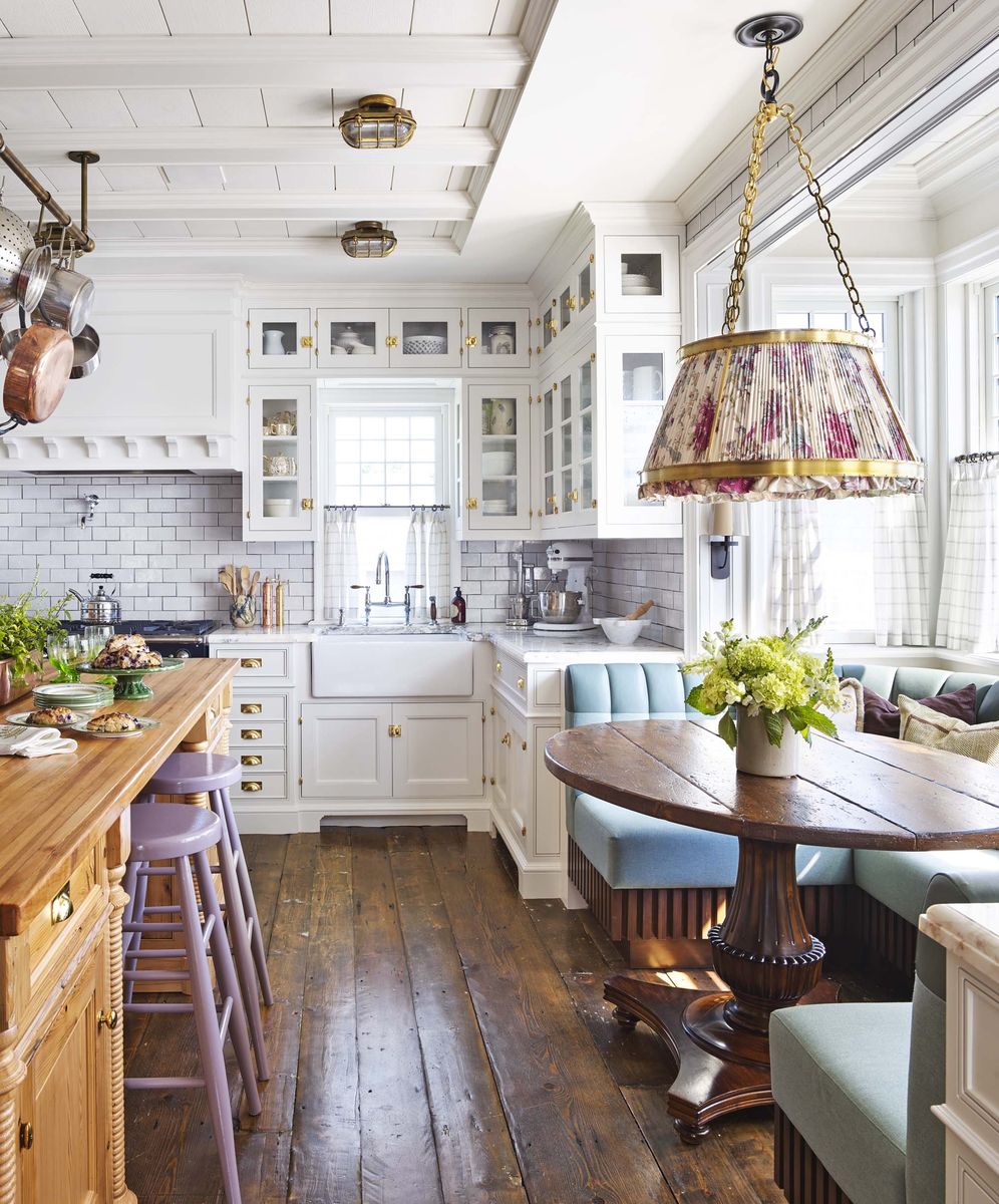 <p>The kitchen in designer <a href="https://philipmitchelldesign.com/">Philip Mitchell's</a> <a href="https://www.veranda.com/home-decorators/a27651886/philip-mitchell-seaside-cottage/">Nova Scotia home</a> is a study in timeless design, starting with the cabinetry, which features a mix of glass-front panel doors on the uppers and Shaker-style doors with a bevel on the lowers. Stacks of drawers with classic brass bin pulls offer variety in storage. </p><p>The banquette seating is crafted of tufted leather and resilient acrylic fabric (both by <a href="https://www.ralphlaurenhome.com/">Ralph Lauren</a>); and an ikat pendant shade (custom, <a href="https://urbanelectric.com/">The Urban Electric Co.</a>) is a brilliant foil for the overhead lighting (bulkhead cage lights, <a href="https://www.capecodlanterns.com/">Cape Cod Lanterns</a>).</p>
