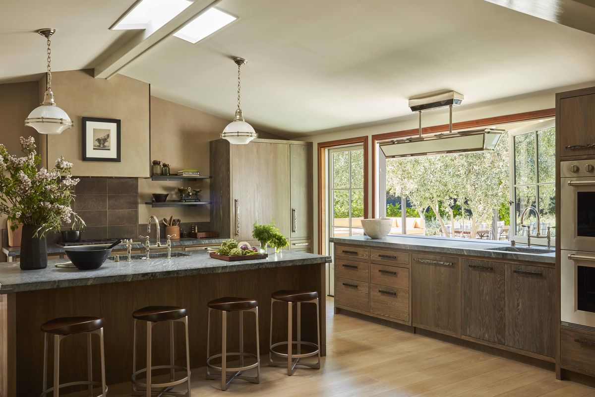 <p>In the kitchen of <a href="https://www.veranda.com/decorating-ideas/house-tours/a38349997/fink-house-tour-napa-valley/">this Napa, California, home designed by Dan Fink</a>, cerused white oak cabinetry, Brazilian soapstone counters, and bronze hardware (<a href="https://www.rockymountainhardware.com/">Rocky Mountain Hardware</a>) lend warmth to the clean, modern lines.</p>
