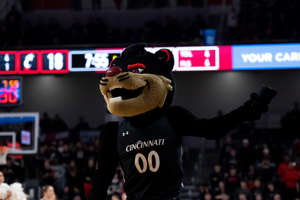 Cincinnati Bearcats mascot holds a t-shirt to throw in the first half of the NCAA men’s basketball game between the Cincinnati Bearcats and the Houston Cougars at Fifth Third Arena in Cincinnati on Sunday, Jan. 8, 2023.