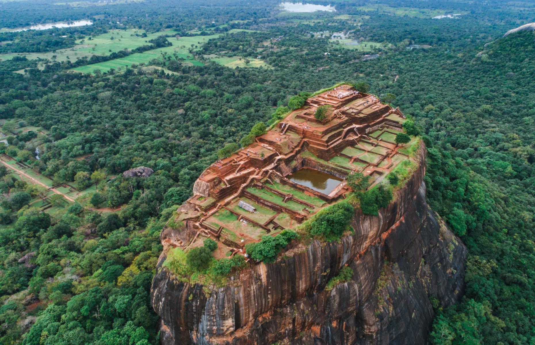 <p>Among the most spellbinding sights in Sri Lanka is Sigiriya, an ancient fortress that juts out above the verdant plains in the country’s northeast. Built by King Kashyapa I in the 5th century AD, the site served as a Buddhist monastery for almost a thousand years, before being abandoned in the 14th century. The only way to access it is through a passageway between a giant pair of rock-hewn lion’s paws, after which you’ll need to climb 1,200 steps to reach the top of the 656-foot (200m) rock column. But we promise the views from the top are worth the climb – visit as early as you can to beat the crowds. </p>