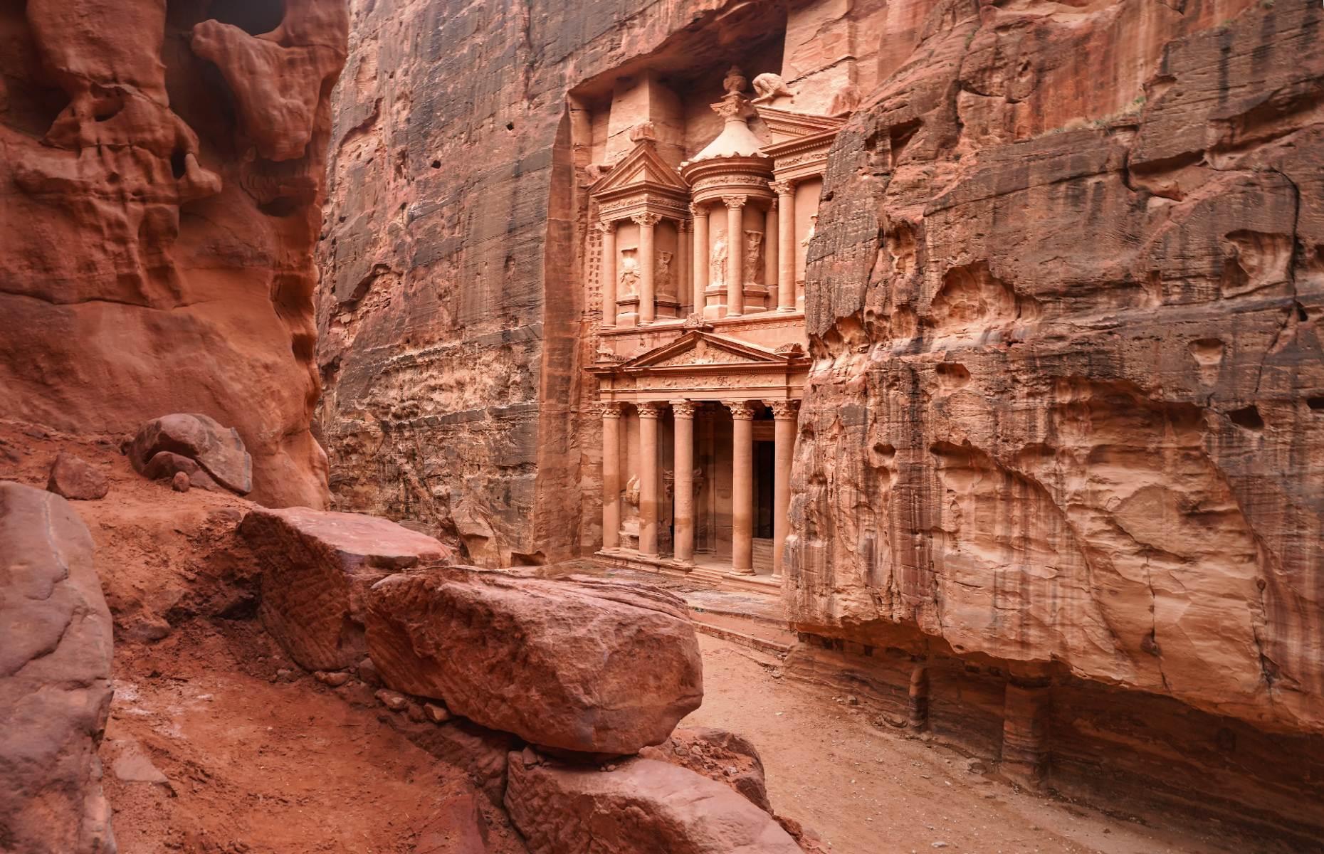 <p>Hidden among the rugged desert landscapes of southwestern Jordan, Petra is an ancient city that was carved into the rock more than 2,000 years ago by the Nabataeans (a nomadic tribe who eventually settled) and it became the capital of their prosperous empire. The most famous structure is the Treasury (pictured), a 131-foot-high (40m) monument complete with columns and intricate carvings, whose exact function is still unknown to experts. Petra Archaeological Park is roughly a three-hour drive from the capital, Amman, and two hours from Wadi Rum.</p>