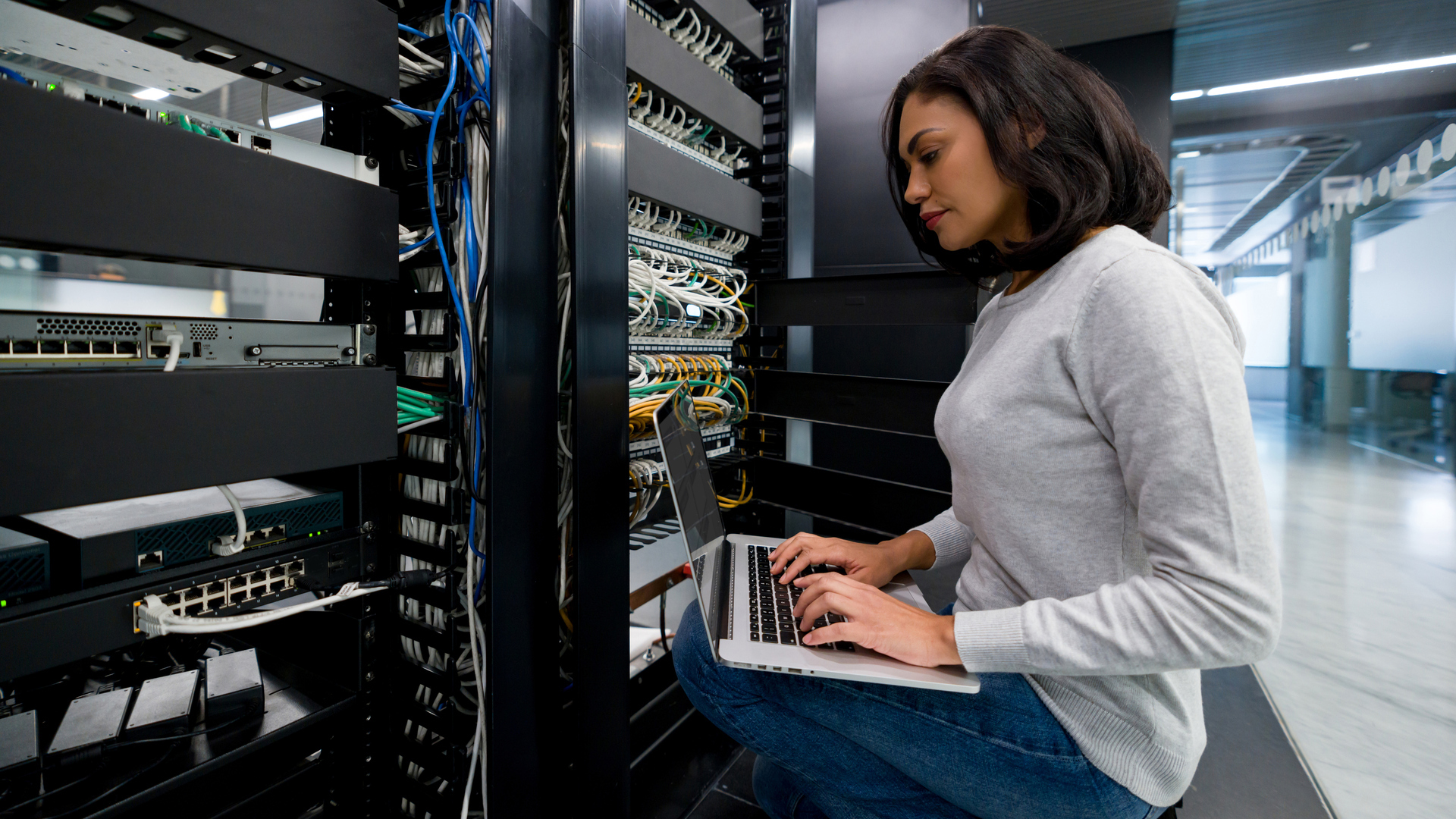 IT support technician fixing a network server at an office