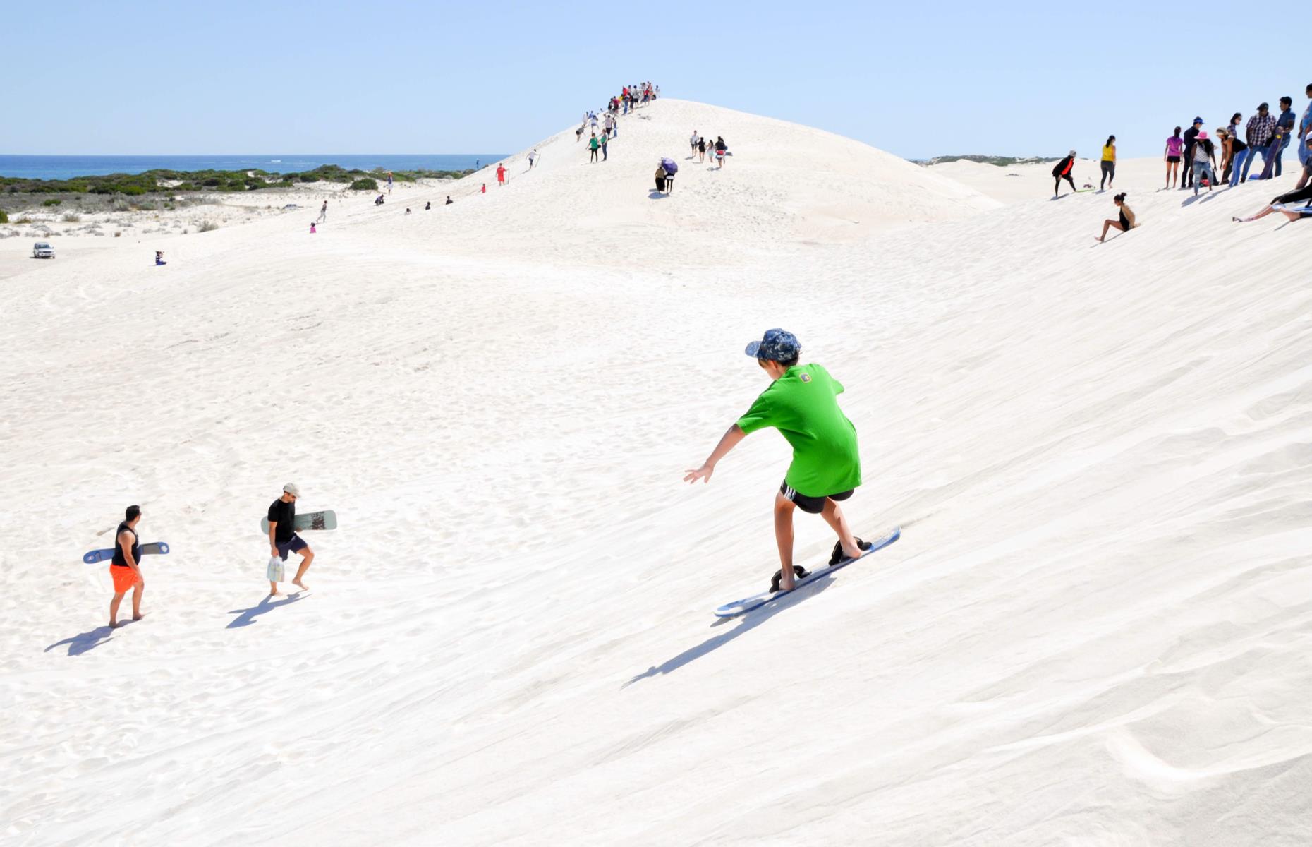 <p>Release your inner kid and whizz down <a href="https://www.lancelin.com.au/tourism/sandboarding/">the towering white sand dunes of Lancelin</a>, a coastal town to the north of Perth. You could join a group, of course, who will have all the kit, rent a board (for a small fee) or take your own for free. Watch the pros, then launch yourself down (it’s best for beginners to sit rather than stand). Don't forget your sunglasses, to stop the glare and sand getting in your eyes. If you’re not a fan of the sand, the seaside town is famed for its surfing and wind surfing too. </p>