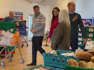 Prince William and Kate joke with each other as they visit food bank