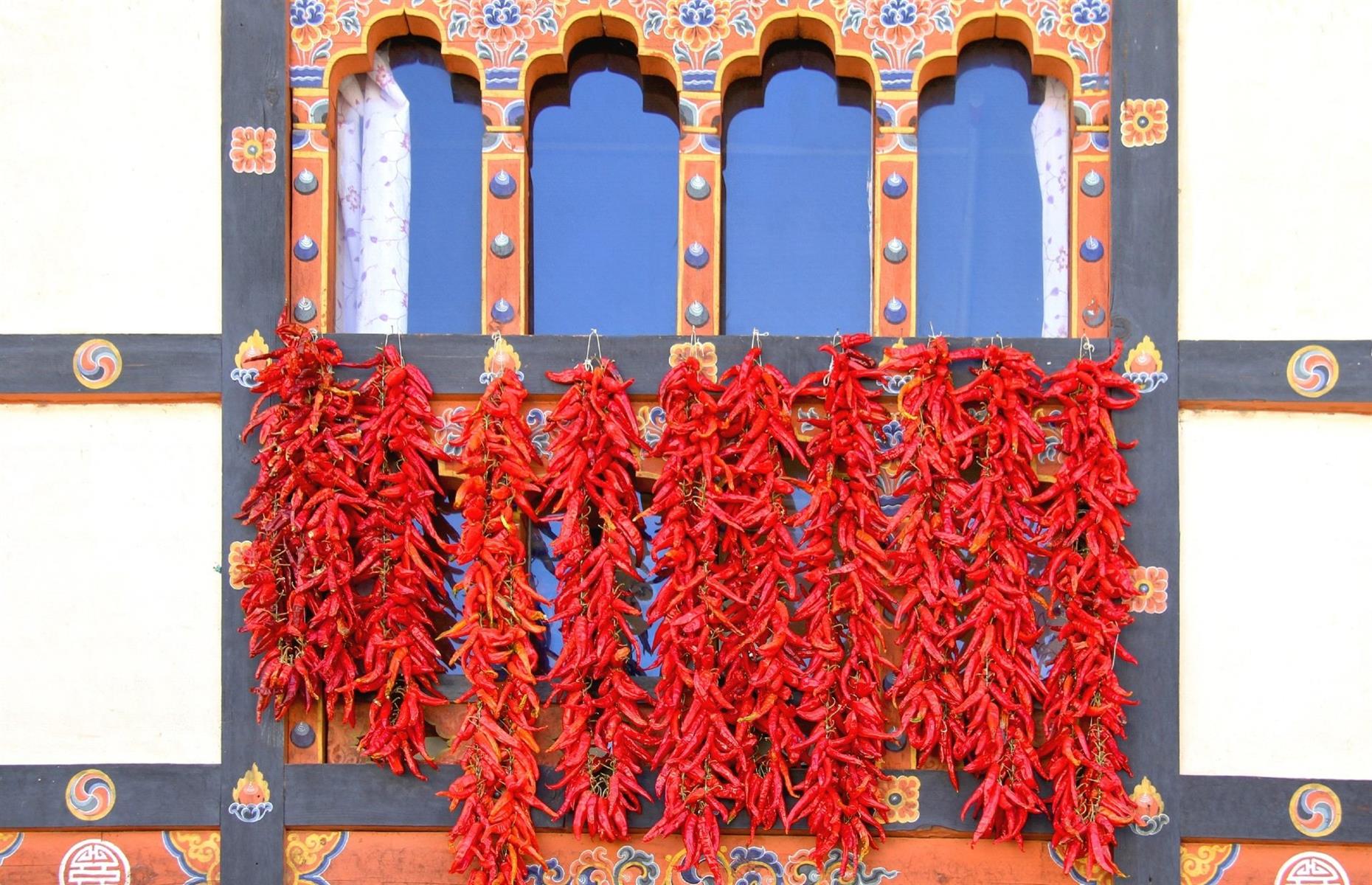 <p>If there’s one food mantra the Bhutanese live by, it’s that spice is king. Influenced by Tibetan, Chinese, Nepalese and Indian cooking, the food in Bhutan is richly flavourful, but it can also be very spicy due to a nationwide love of chilli peppers. While you can try milder, tourist-friendly versions of regional favourites in lots of places, we recommend sampling an authentic (and super-hot) taste of what the locals eat at least once, whether it’s jasha maru chicken stew, or the nation's signature dish, ema datshi – a chilli cheese that’s so beloved, it comes with almost every meal.</p>