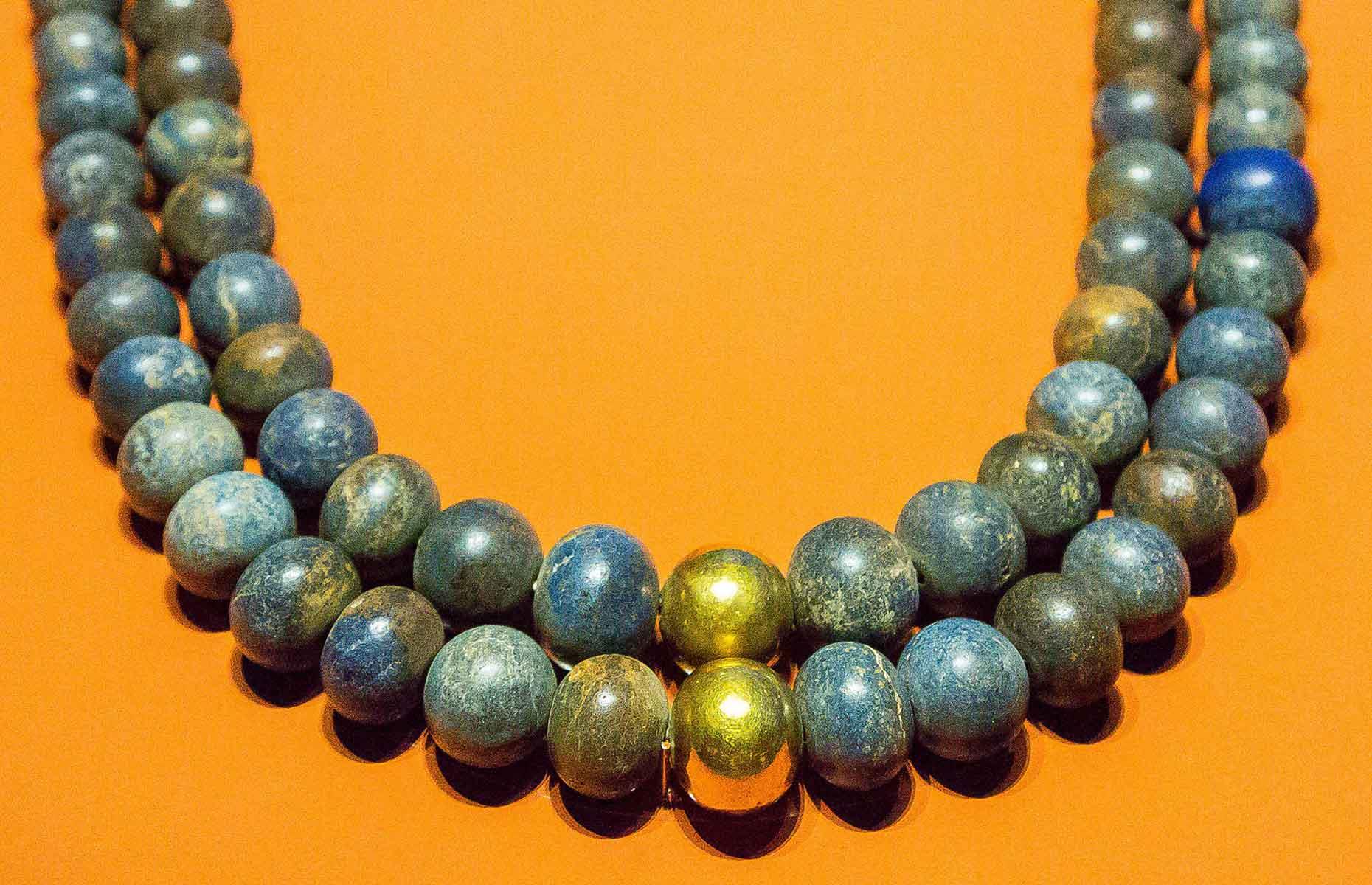<p>This beaded necklace was found in king Psusennes I's tomb. The two rows of beads are made from lapis lazuli with two golden beads in the middle, and date back to roughly 1069-945 BC. Unusually, there's an <a href="https://nilescribes.org/2017/08/19/lecture-tanis-egypt-capital-and-royal-tombs/">Assyrian inscription</a> on one of the beads, and historians are still unsure as to why this foreign item was found in an Egyptian king's tomb...</p>