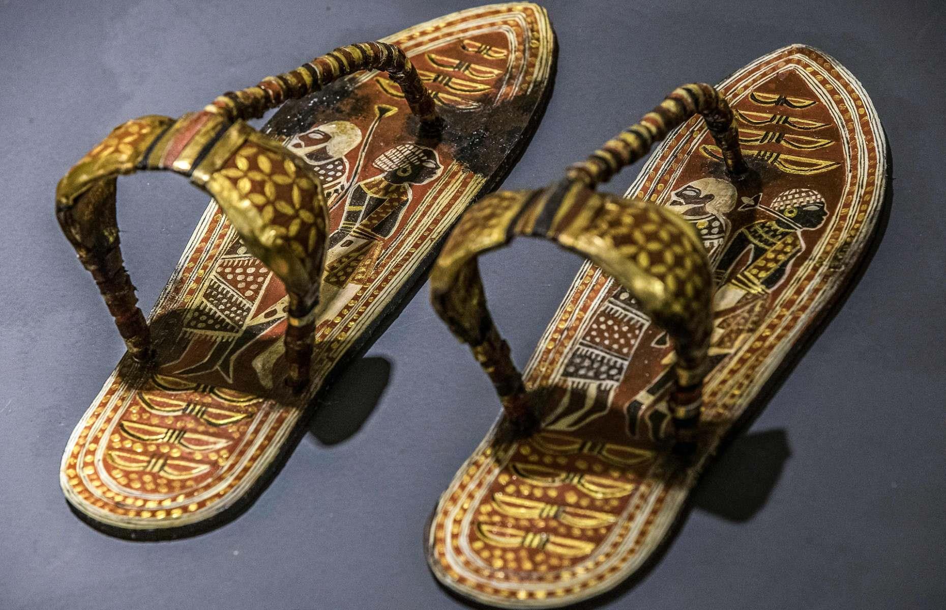 <p>Sandals and toe stalls (golden toe coverings) were discovered on many Egyptian mummies, including Tutankhamun. Pictured here is a replica of a pair recovered from King Tut's tomb, where some 80 pairs were found in total. These funerary items served symbolic purposes; on each sole are figures and arches representing Egypt’s nine traditional enemies, which the pharaoh symbolically trod on.</p>
