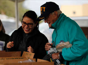 Sheila Cazares, a Collier County Health Dept. staff member, assists U.S. Navy veteran William White select a handful of supplies. Volunteers for the Collier County Hunger & Homeless Coalition were in East Naples Friday, January 27, 2023 to conduct the annual "Point in Time" homeless count and provide supplies to the homeless.