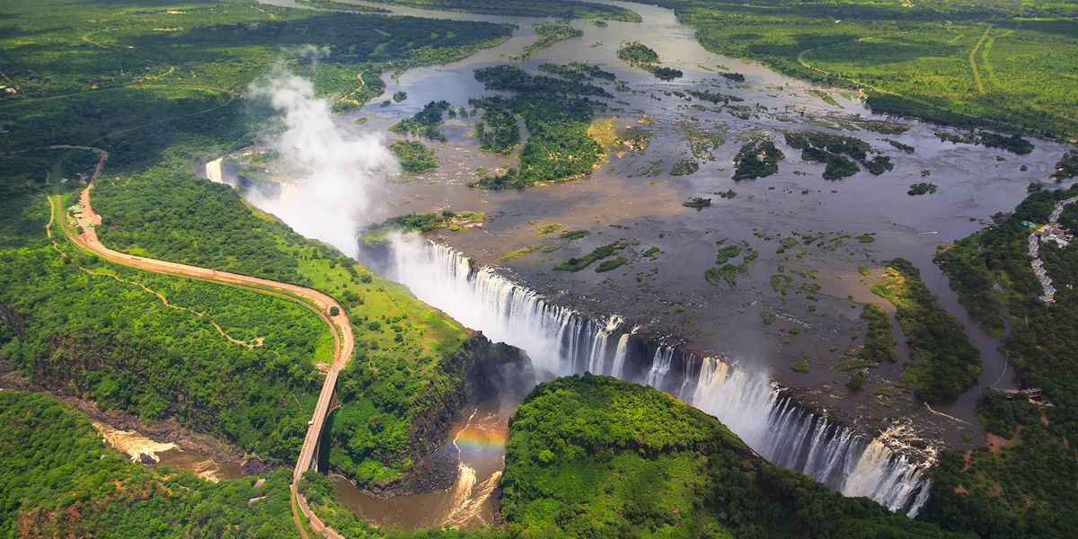 <p>Victoria Falls straddles the border between Zambia and Zimbabwe on the Zambezi River. One of the best vantage points in which to view this mile-long waterfall is from <a href="https://go.redirectingat.com?id=74968X1553576&url=https%3A%2F%2Fwww.tripadvisor.com%2FAttraction_Review-g298089-d638662-Reviews-Livingstone_Island_Tour-Livingstone_Southern_Province.html&sref=https%3A%2F%2Fwww.roadandtrack.com%2Foffbeat%2Fg42712062%2Fmost-beautiful-places-in-the-world%2F">Livingstone Island</a>, so named for David Livingstone, the first Westerner to come across the falls in 1855. </p><p>Vic Falls has long been considered one of the most beautiful places in the world — and one of the most adventurous, with bungee jumping, zip lining, and white-water rafting all in the vicinity of the falls. </p>