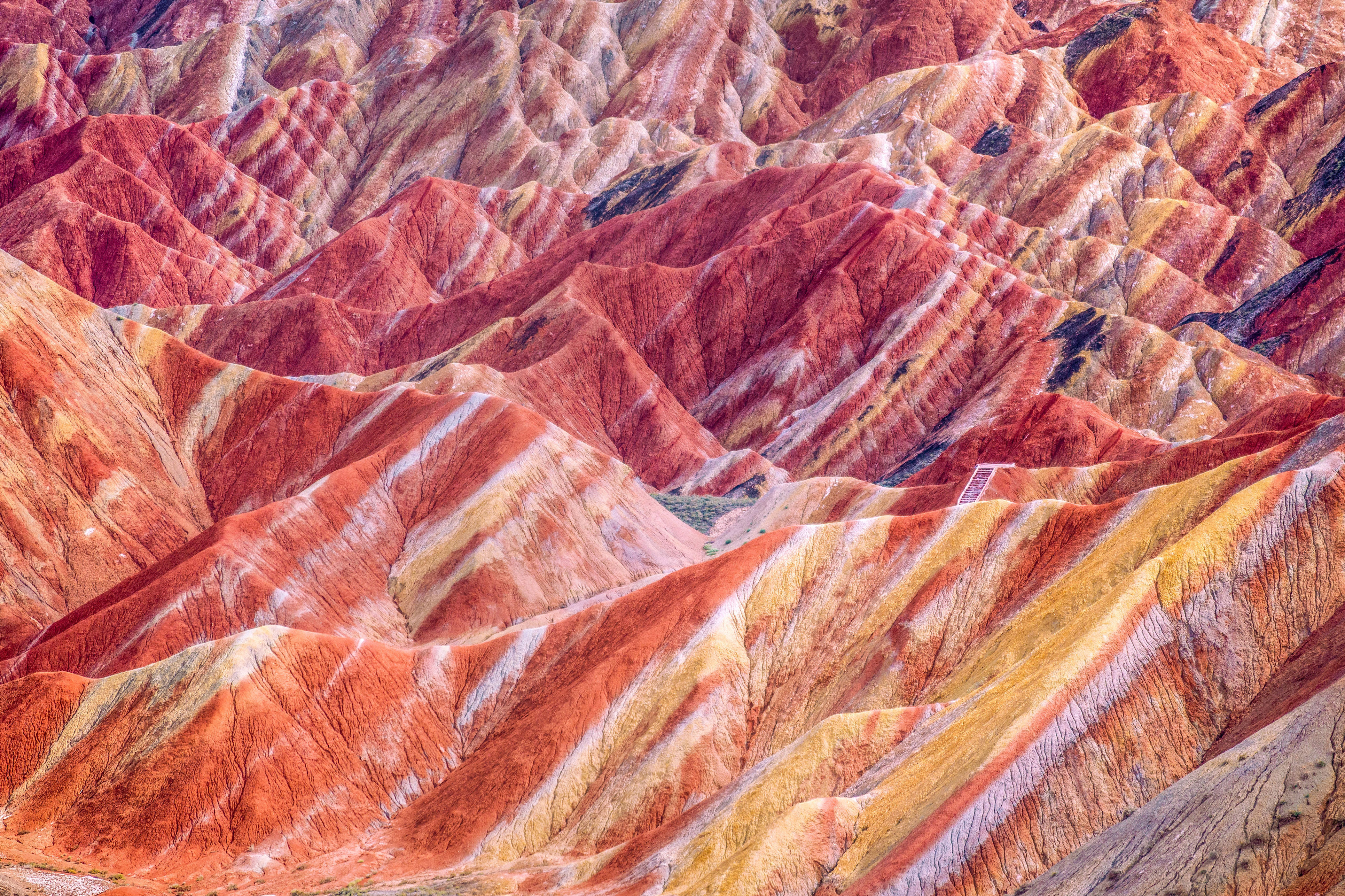 <p>These striped, technicolor mountains are Mother Nature’s answer to Photoshop. Red sandstone and mineral deposits have been building up in China’s Zhangye National Geopark (formerly Zhangye Danxia Geopark) for more than 20 million years, causing the surreal layered effect.</p> <p><strong>Get the shot:</strong> There are a couple of viewing platforms surrounding the geopark. The highest platform comes at the end of a rather grueling climb up hundreds of steps, but the trek allows you to take in panoramic views of the rainbow mountains (bonus points for sunset photos).</p>