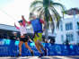 Maura MacNeill of Ft. Myers Beach and another runner cross the finish line hand in hand during the Barron Collier Companies Naples Half Marathon in Naples on Sunday, Jan. 15, 2023.