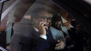 Rep. George Santos, R-N.Y., speaks on a phone as he departs Capitol Hill in Washington, Wednesday, Jan. 11, 2023.