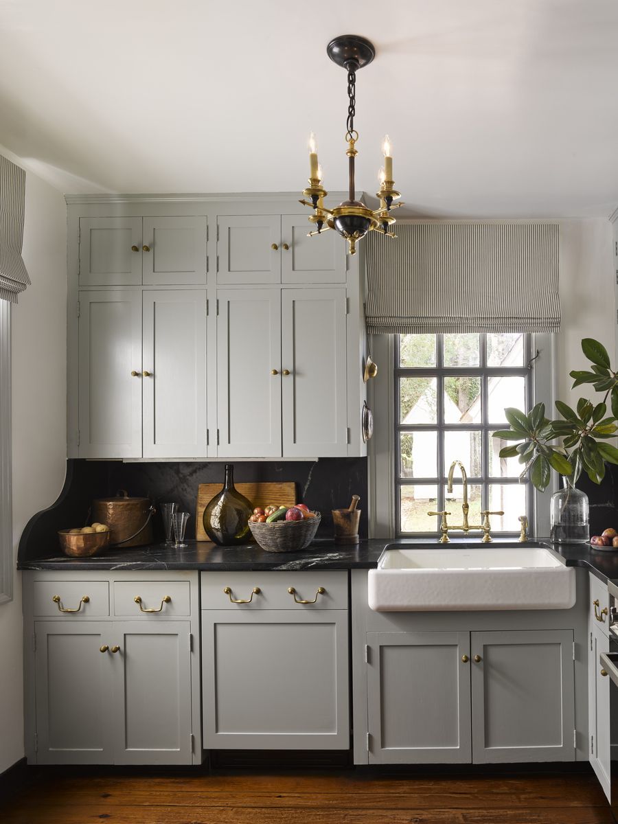 <p>This appliance is hidden under cabinetry panels that, along with brass pulls (<a href="https://modern-matter.com/">Modern Matter</a>), imbues the kitchen with early American ambience. The candelabra-style chandelier is by <a href="https://www.visualcomfort.com/">Circa Lighting</a> and the farm sink and bridge faucet are by <a href="https://www.fergusonshowrooms.com/">Ferguson</a> in <a href="https://www.veranda.com/decorating-ideas/house-tours/a42046008/heather-chadduck-hillegas-colonial-williamsburg-home-tour/">this Colonial Williamsburg home designed by Heather Chadduck Hillegas</a>.</p>