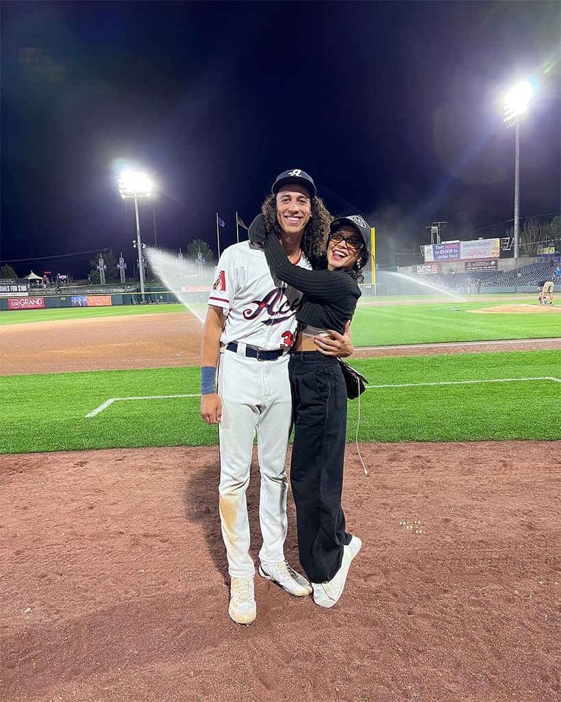 The actress appears with her partner on the baseball field.