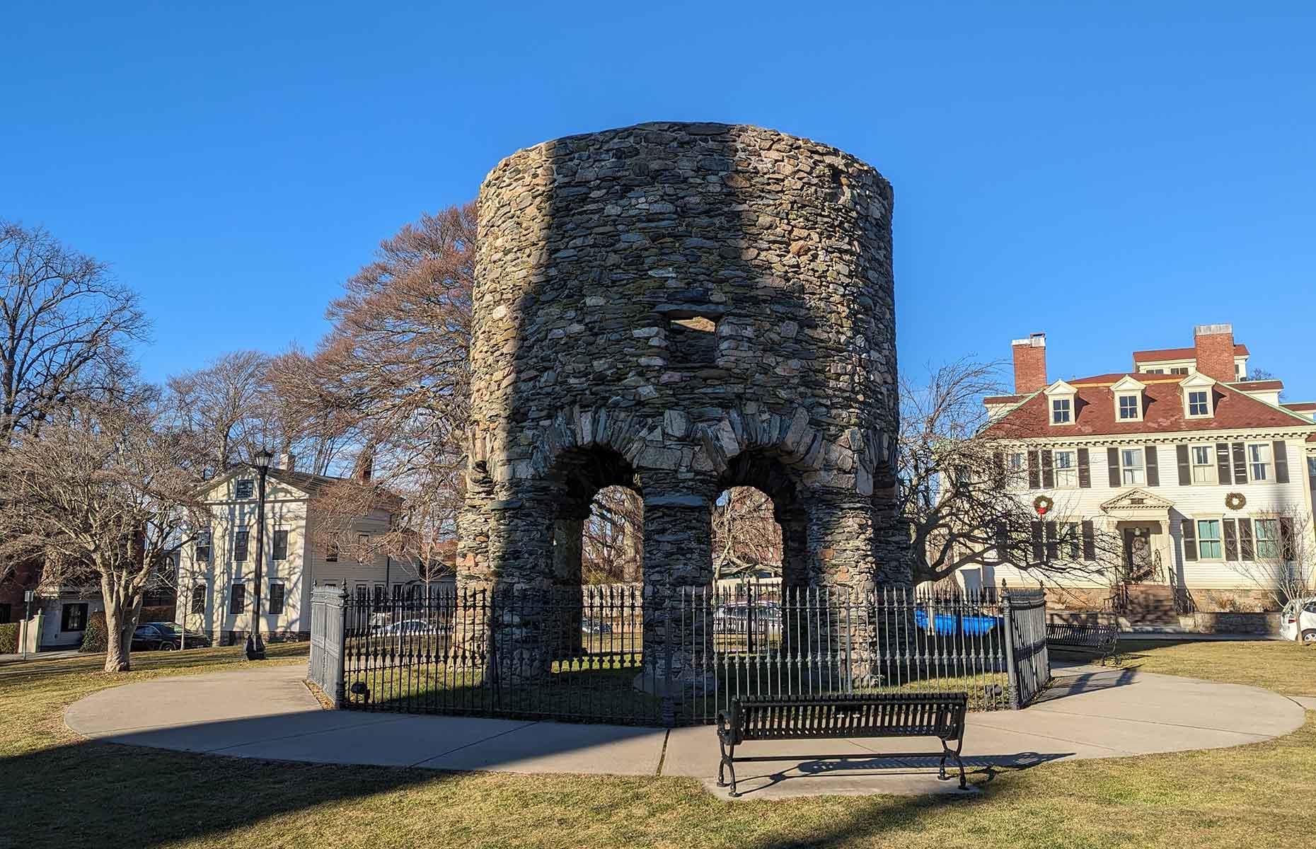 <p>Will we ever solve the mystery of who built Newport Tower? Generally accepted to have been constructed <a href="https://locationsoflore.com/2018/11/21/the-enigmatic-origins-of-the-newport-tower/">as a windmill</a> in the 17th century (parts of the structure were radiocarbon-dated to 1635-1698), there are also theories that it could be of Portuguese, Scottish, Chinese or even Viking origin. Several astronomical alignments add to the mystery too. Visit the structure and <a href="http://newporttowermuseum.com/">Newport Tower Museum</a> in Touro Park to decide for yourself…</p>  <p><strong><a href="https://www.loveexploring.com/galleries/163256/viking-invasion-surprising-faraway-places-they-travelled-to?page=1">See the surprising places the Vikings traveled to</a></strong></p>