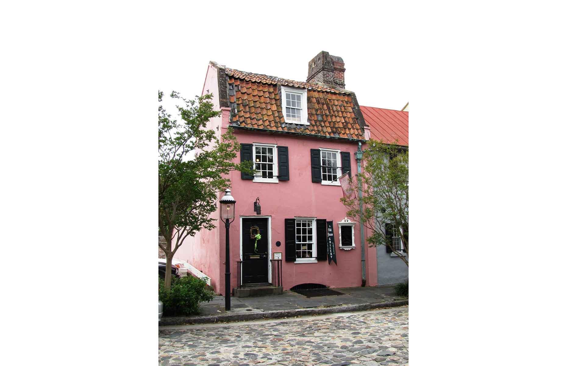 <p>With its original gambrel roof and surrounding cobblestone road, this petite palace really does make you feel as if you're walking the streets of France. This is the <a href="https://chstoday.6amcity.com/history-of-the-pink-house-17-chalmers-st-in-charleston-sc">Pink House</a>, located in Charleston's French Quarter, built in 1690 as a tavern (and brothel). It has since been used as a law office, private residence and now an <a href="http://pinkhousegallery.tripod.com/">art gallery</a>, with one room on each of its three floors. There's talk of it returning to a private residence again, so see it while you can – but if you do miss out its photogenic exterior and plaque make a visit worthwhile.</p>