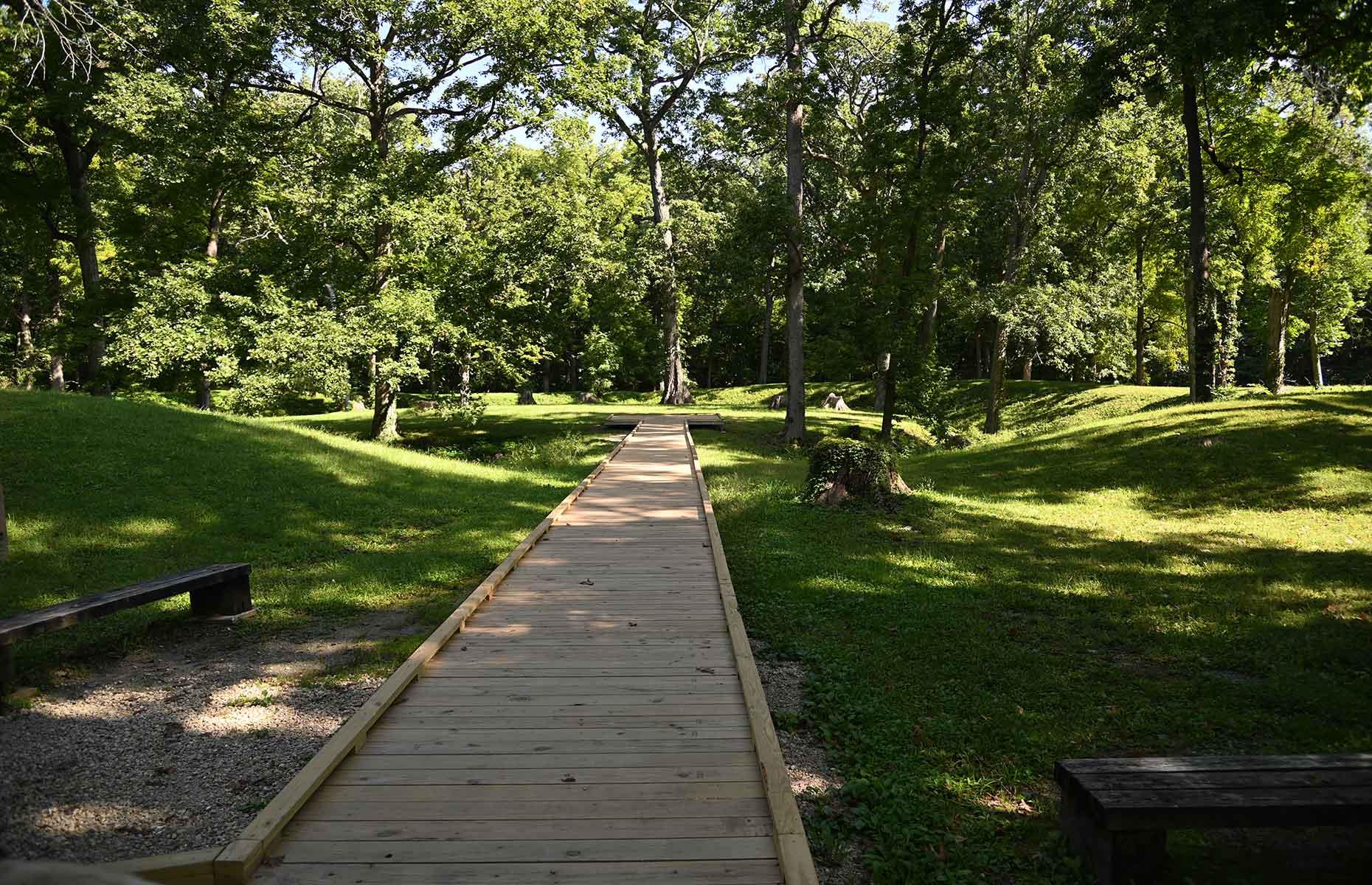 <p>The 10 earthworks that make up <a href="https://www.in.gov/dnr/state-parks/parks-lakes/mounds-state-park/">Mounds State Park</a> were built between 250 BC and AD 50, and the largest earthwork – the Great Mound – dates to 160 BC. These piles were the work of the Adena-Hopewell people, who gathered at these elevated areas for <a href="https://publichistory.iupui.edu/items/show/182">ceremonies</a> and to view astronomical alignments such as the <a href="https://www.visitindiana.com/blog/post/mounds-state-park/">summer and winter solstices</a>. The park also includes a visitor center, nature center and dedicated campground.</p>