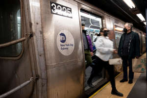 Passengers disembark a train in the Manhattan subway system, Monday, Feb. 21, 2022, in New York.