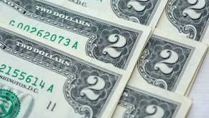 pile of 2 US dollars bills, finance concept