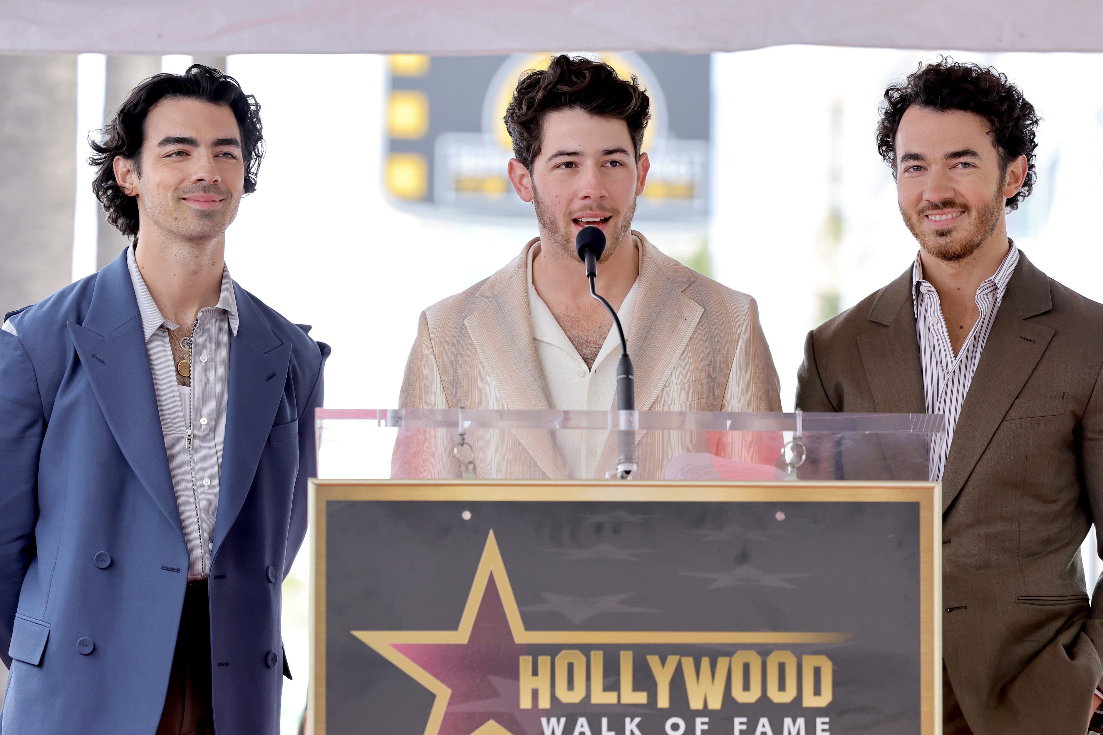 (From left) Joe Jonas, Nick Jonas and Kevin Jonas spoke onstage at the Hollywood Walk of Fame star ceremony.