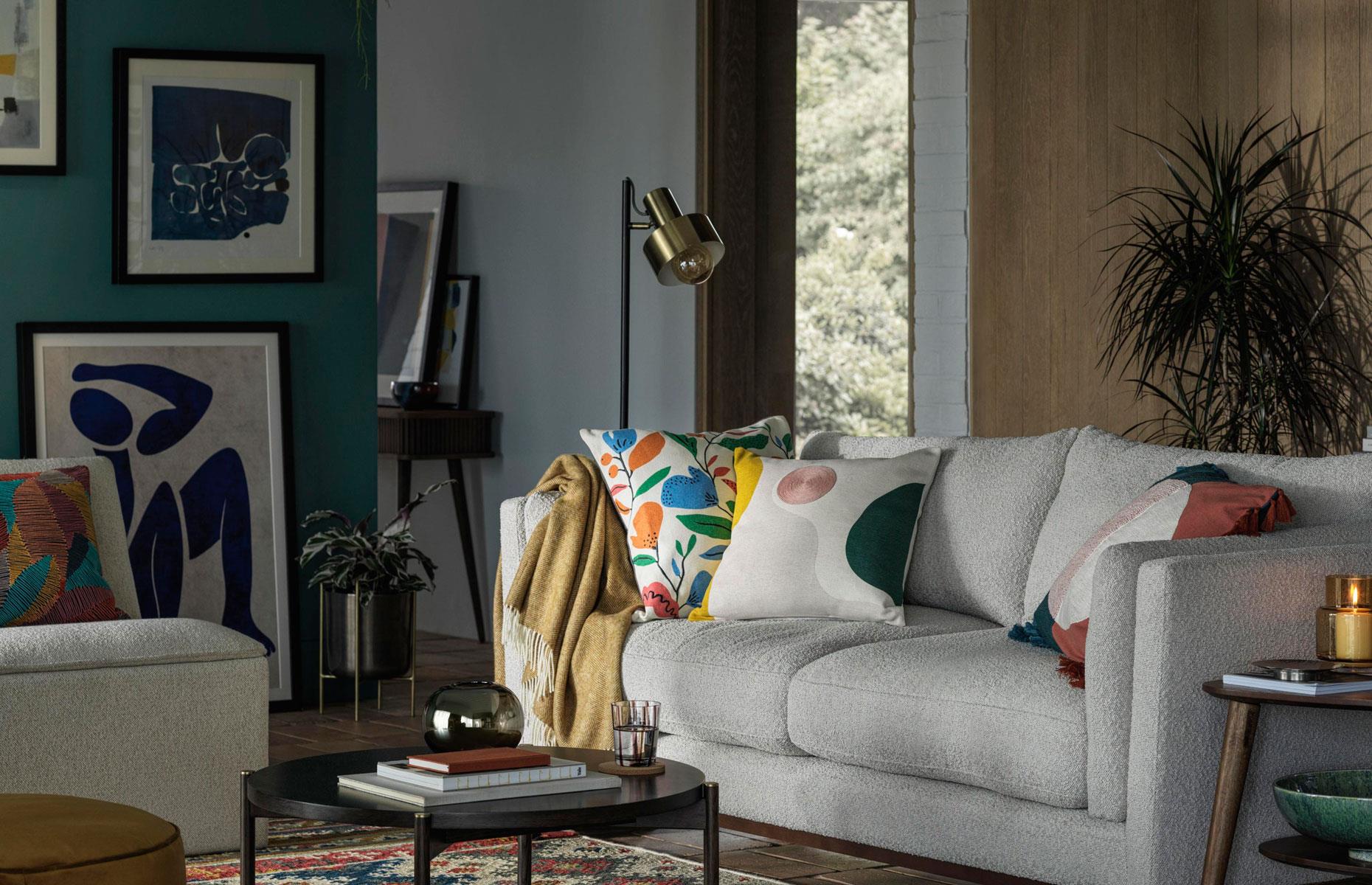 <p>Large open-plan living rooms can lack character so adding personal objects will make the space feel homely. Rich teal creates an interesting base for this picture wall, creating a flexible focal point that anchors the scheme. Mid-century furniture and pops of mustard and terracotta add to the eclectic look of this inviting family space.  </p>