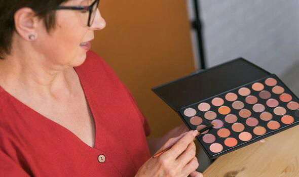 Woman shows brown shades in eyeshadow palette