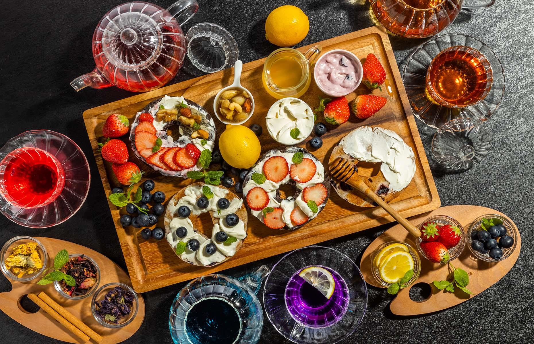 <p>Want to try a board-shaped take on brunch? Cover a wooden platter with sliced bagels smeared with a variety of sweet and savory toppings, and sprinkle with edible flowers for an Instagram-worthy look. Serve it with a steaming pot of your favourite tea, or make it boozy with a mimosa or two.</p>  <p><a href="https://www.lovefood.com/recipes/57971/blueberry-and-cranberry-bagels-recipe"><strong>Get the recipe for blueberry and cranberry bagels here</strong></a></p>