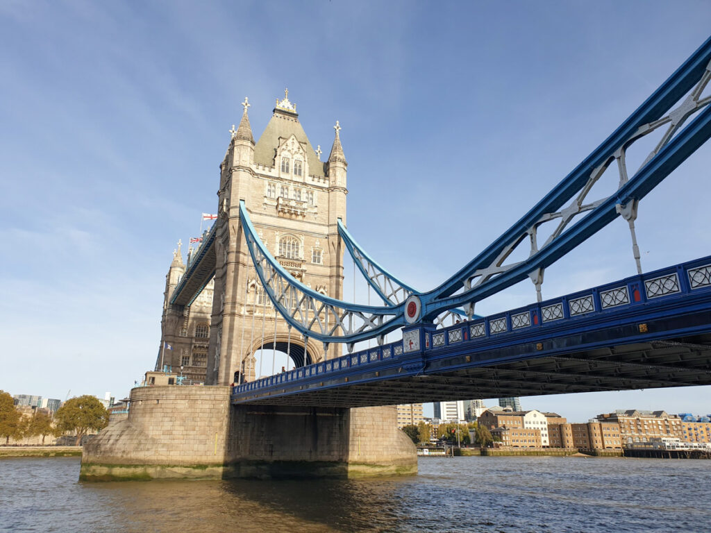 <p><em>By Claire of Go South West England</em></p> <p>One of London’s most famous and prestigious landmarks, Tower Bridge has been delighting travellers for over 100 years. </p> <p>Dating back to the late 19th century, Tower Bridge was built to give better access to the East End <a href="https://wanderwithalex.com/things-to-do-in-london/">of London</a>. When it was built, it was one of the most sophisticated in the world, with neo-Gothic architecture and hydraulic-operated bascules. It was opened on 30th June 1984 by the then Prince and Princess of Wales. </p> <p>It's been restored over the years and has periodically been painted different colours on jubilees and other national celebrations. The bridge rarely closes, so even if you're <a href="https://europeinwinter.com/london-in-winter" rel="noreferrer noopener">visiting London in winter</a>, you should still be able to enjoy it!</p> <p>Contrary to popular belief, Tower Bridge and London Bridge are two different things. London Bridge sits a 15 minute walk away; this bridge was built in the 70s, but it replaced a 19th century bridge which replaced a 600 year old medieval bridge. London Bridge is a lot more nondescript, but you can get an immense view of Tower Bridge from it! </p>