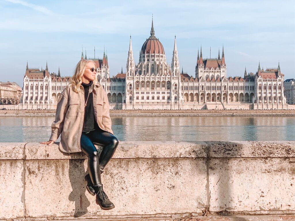 <p><em>By Brianna West of Travel Munchers</em></p> <p>Budapest's most recognizable building, sits majestically along the east bank of the Danube. The Hungarian Parliament building is unmissable during a <a href="https://travelmunchers.com/budapest-hungary/" rel="noreferrer noopener">trip to Budapest</a>. Its buttresses, towers and mighty dome are dazzling from near and far. It is especially impressive at night. If you want a unique experience take a night river cruise and you will see it beautifully illuminated in a golden glow. </p> <p>Its official name is Orszaghaz which translates to “House of the Country” or “House of the Nation”. Orszaghaz is situated on Kossuth Square in the Pest side of the city, on the eastern bank of the Danube.</p> <p>A competition to design the Hungarian Parliament Building was held in 1883. There were only 19 plans submitted and the winning design was proposed by Hungarian architect Imre Steindl. His plans included a neo-Gothic style and construction began in 1885. It took 1,000 workers and 17 years to build the Parliament. It was scheduled to be finished by 1896 to celebrate the 1,000th anniversary of Hungary's foundation, but was not completed in time, instead it opened in 1902.</p> <p>It has been the largest building in Hungary since its completion and houses 691 rooms.</p> <p>Crazy fact: The Parliament building was so expensive, the money used to build it would have been enough to construct a small city! The inside contains intricate ceiling designs accented with a large amount of gold- 40 kilograms! </p>