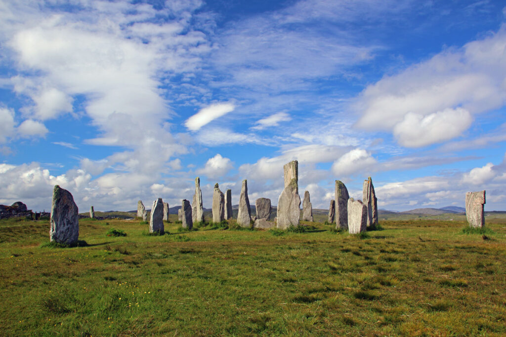 <p><em>By Kristin of Scotland Less Explored</em></p> <p>The Callanish Stones are located on Lewis in the Outer Hebrides in Scotland. The site is often called the "Stonehenge of the North" but it was erected over 5,000 years ago and is actually older than Stonehenge.</p> <p>Although it is an important Scottish landmark, probably due to its location, it is much less visited than Stonehenge. This means that you might have the site to yourself and you can walk freely amongst the 13 stones that stand in a circle. The monolithic stone in the middle is nearly 5 metres tall!</p> <p>There is a car park and visitor centre close to the stones where you can learn more about the history of the site. However, it is quite fascinating that nobody knows what the site was used for. One theory is that it was an astronomical observatory; another is that it was used for rituals over 2,000 years. According to local folklore the stones are petrified giants who would not convert to Christianity. </p> <p>A short walk away is another stone circle. It is smaller than the main one but its presence indicates how important this site must once have been.</p> <p>After visiting this amazing landmark don't miss the fantastic landscape and <a href="https://scotlandlessexplored.com/ardroil-beach-uig-lewis/" rel="noreferrer noopener">beaches on Isle of Lewis</a>.</p>