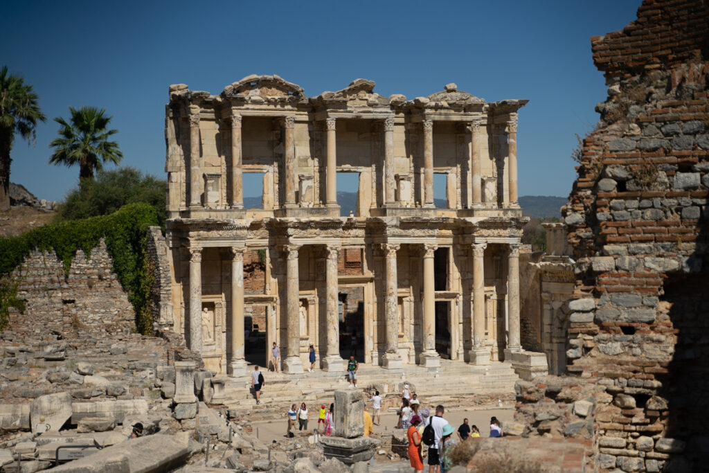 <p><em>By Louisa Smith of The Turkey Traveler</em></p> <p>Located just 55km outside of Izmir in Turkey, is the UNESCO World Heritage Site of Ephesus. This ancient city is one of the oldest cities in Turkey, dating back to the time of the Ancient Greeks.<br><br>Though the exact date it was built is unknown, legend has it that the Ionian Greeks built it in the 11th century as a trading port. Due to its location, it was one of the most important trading centers in the Mediterranean Region and the city had tremendous wealth.<br><br>Although the city lies in ruins today, you can still evidence of that wealth in the beauty and intricacy of the architecture found in the ruins.<br><br>One of the most important <a href="https://theturkeytraveler.com/visiting-ephesus/" rel="noreferrer noopener">landmarks in Ephesus</a> is the Temple of Artemis, which has been dubbed one of the seven Wonders of the Ancient World. In its prime, it was estimated to be four times bigger than the Parthenon in Athens. Today it is little but a column.<br><br>A beautiful landmark in Ephesus worth checking out is the Library of Celsus, whereby the outer facade is still well-preserved, with intricate Greco-Roman reliefs, arches, columns, and statues nestled in alcoves.<br><br>Ephesus was always an important city. It was even said that the Virgin Mary and St. John had visited Ephesus, which features in the New Testament.<br><br>However, the city declined after the River Kaystros dried out which meant that Ephesus could no longer operate as a trading port. Then it was hit by a devastating earthquake in the 6th and 7th centuries, destroying much of the city.<br><br>The final straw came when the Byzantine Arabs invaded, and the people of the city abandoned it to seek safety elsewhere. And it has been left to ruin ever since.<br><br>Today, visitors can still see the remains of the Greek theater, which could once hold 24,000 people, as well as the wealth of columns, roads, and broken walls where buildings once stood over a 415-hectare site, offering a hint at what used to exist here thousands of years ago.</p>