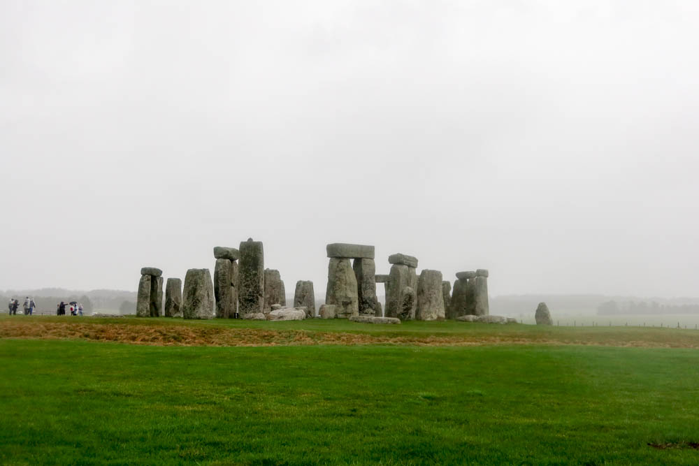 <p><em>By Claire of Go South West England</em></p> <p>Stonehenge is without a doubt one of the world’s best landmarks, and among the greatest <a href="https://gosouthwestengland.co.uk/places-to-visit-in-wiltshire" rel="noreferrer noopener">places to visit in Wiltshire</a> and all of England. </p> <p>This ancient stone circle is thought to be created by early Mesolithic hunter-gatherers around 5000 years ago for ceremonial purposes, although it could have also been used as an astronomical clock. </p> <p>The biggest mystery surrounding the monument is how the stones got there. They actually come from South Wales, some 160 miles from their current site on Salisbury Plain. They were dragged here, at a time when wheels didn’t exist, and nobody is too sure why!</p> <p>Stonehenge is closest to Salisbury; you can get there by taking the train to Salisbury and connecting to a bus service. Alternatively, there is a large car park on-site. If you are an English Heritage or National Trust member, you can get free entry (it’s on National Trust ground but the stones themselves are English Heritage!). </p>