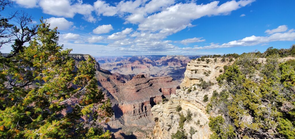 <p><em>By Steve Morrow of Paddle About</em></p> <p>The Grand Canyon is one of America’s most popular tourist destinations, with roughly 5 million visitors annually. This natural wonder is located in northwest Arizona, snuggled up next to Utah and Nevada. The mile-deep canyon was carved by the Colorado River over millions of years to leave the beauty we see today.</p> <p>The canyon is 277 miles long, separating the North and South Rims. One of the most interesting tidbits about the Grand Canyon is that it averages about 10 miles across. Still, it takes about 5 hours to drive around from rim to rim. </p> <p>Most people visit the South Rim since it is much easier to access than the remote North Rim. In addition, there is a distinct elevation difference between the two rims, with the South Rim sitting at 7,000 feet and the North Rim at 8,000 feet. As such, the North Rim has cooler temperatures with noticeably different vegetation and scenery than its southern counterpart. </p> <p>Hiking is a popular activity at the Grand Canyon. You will hear folks talking about the vaunted “rim to rim,” or even more elusive, “rim to rim to rim,” which is <em>exactly</em> what it sounds like. Hikers make their way from one rim to the other and back again, some even accomplishing the feat in a single day while others camp for the night at Phantom Ranch at the bottom of the canyon.</p> <p>Other popular points of interest at the Grand Canyon include the Grand Canyon Skywalk, the South Rim Village, and North Rim Village. If you can <a href="https://paddleabout.com/best-time-to-visit-the-grand-canyon/" rel="noreferrer noopener">visit the Grand Canyon</a>, take the opportunity. You will not be disappointed.</p>