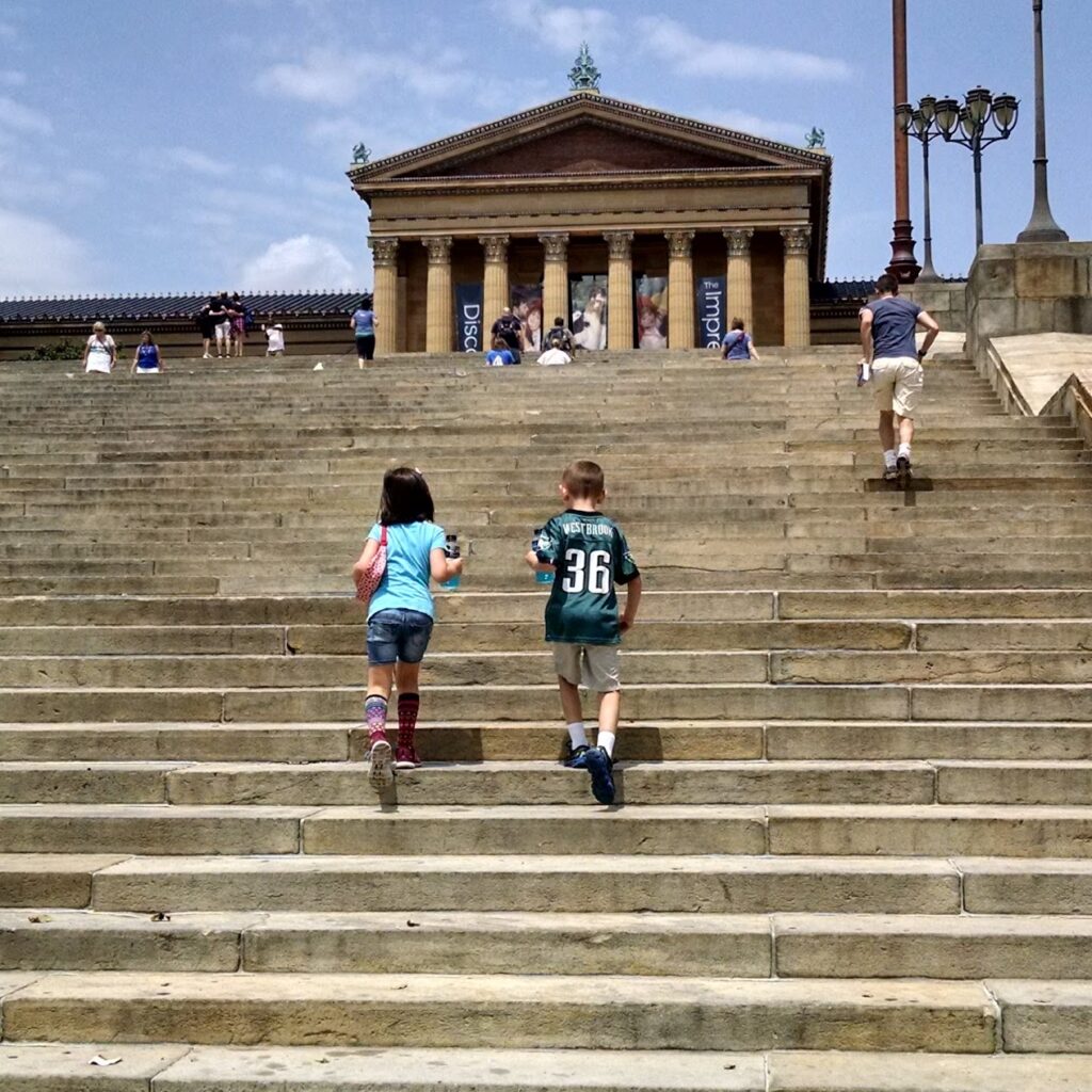 <p><em>By Lisa Lightner of A Day in Our Shoes</em></p> <p>When the media talks about <a href="https://wanderwithalex.com/things-to-do-in-philadelphia-pa/">Philadelphia</a>, they love to show you images of the famous “Rocky steps.” And sure, it’s an iconic scene from an iconic movie that perfectly describes the city’s vibe.</p> <p>But very few encourage you to go inside the art museum, which is just as breathtaking. </p> <p>An art museum might feel tedious if you aren’t into art appreciation. But in recent years, the Philadelphia Museum of Art has beefed up its programming to include <a href="https://adayinourshoes.com/sensory-friendly-philadelphia/" rel="noreferrer noopener">family-friendly events and activities</a>. They do an “Art Reach” program for children every summer. </p> <p>And a must-see within the museum is the Arms and Armor room. My boys love it at any age. Seeing ancient helmets and weapons made learning fun for them. The museum’s collection of artifacts spans 4000 years!</p> <p>Philadelphians love our Rocky steps. Greek architecture-style buildings like it just aren’t constructed today and are beautiful. </p> <p>But, take time to actually step inside the museum buildings, which total almost 1 million square feet. With over 500,000 items in the collection, there indeed is something for everyone to enjoy and learn.</p>