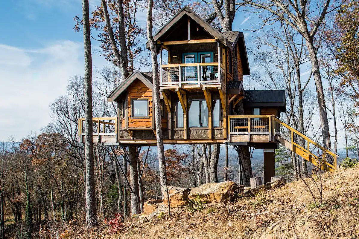 <p>Want to stay in a literal treehouse? Caroline and Mike have you covered. <a href="https://www.airbnb.co.uk/rooms/plus/23495700">The Sanctuary</a> sits atop tall white oaks overlooking mountains and miles of forest. </p><p>It has a balcony on the side with rocking chairs, perfect for stargazing, and enough space to sleep four people comfortably. For a tiny house, the Sanctuary is quite spacious. It has a double bed in the loft room and a pull-out in the living area.</p><p>You’ll get a real sense of space on the 16-acre lot, but it’s within driving distance of downtown. </p>