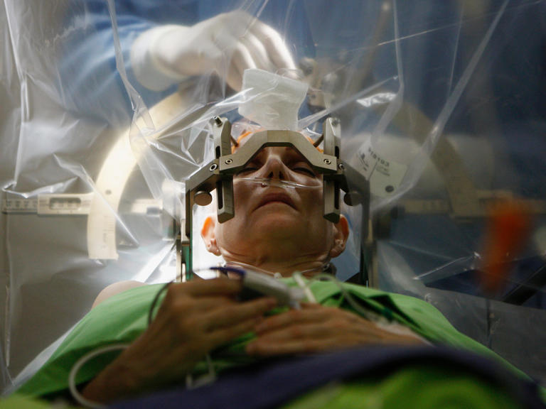 A woman undergoes deep brain stimulation surgery — a type of brain-computer interface that can help people with Parkinson's Disease. Bernadett Szabo / Reuters