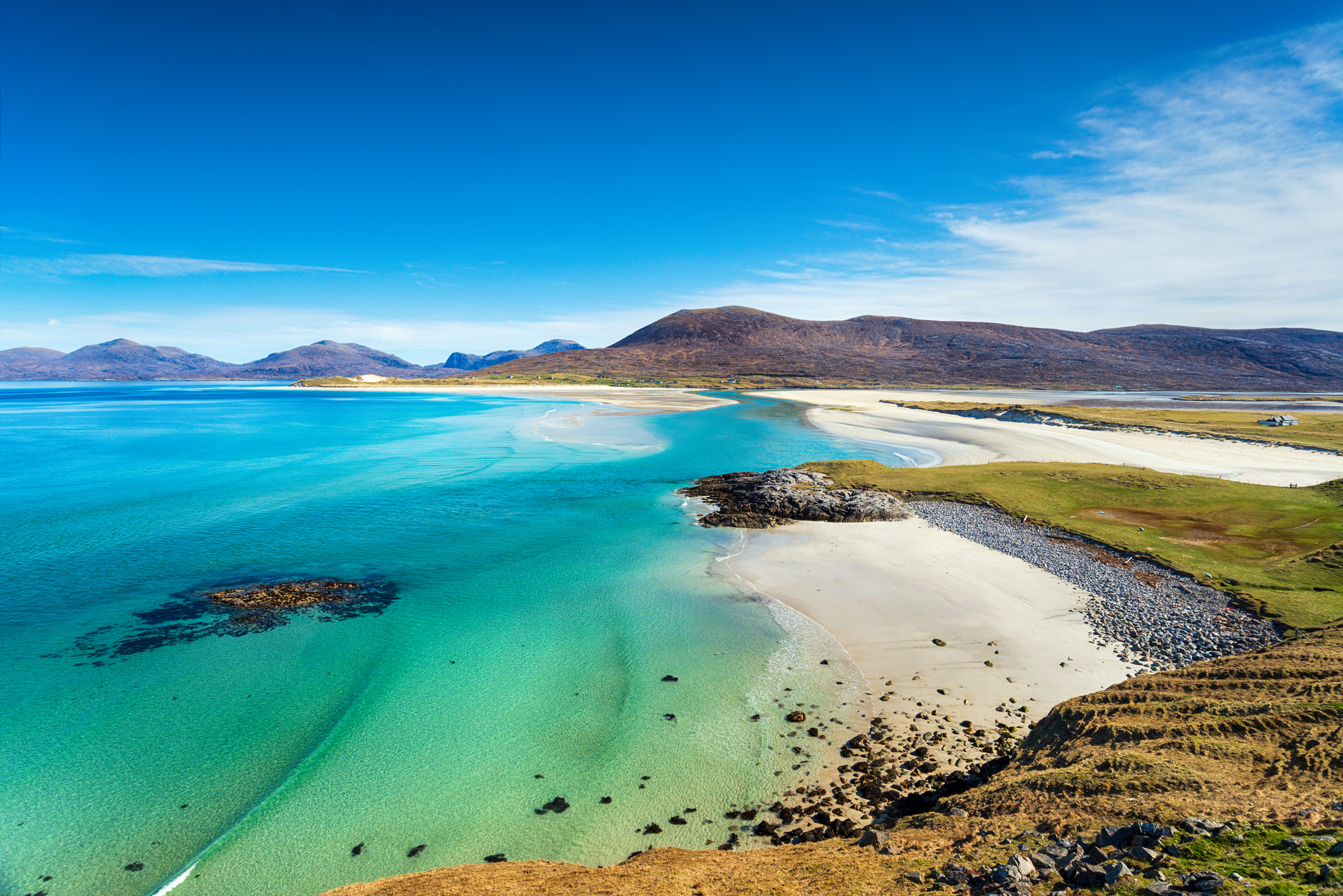 In the heart of the <a href="https://explore-harris.com/" rel="noreferrer noopener">Outer Hebrides</a>, the Isle of Harris is home to spectacular scenery bordering the Atlantic Ocean. Among its many white sandy beaches, Luskentyre and <a href="https://www.visitscotland.com/info/see-do/traigh-seilebost-p2571581" rel="noreferrer noopener">Seilebost</a> offer splendid mountain views, turquoise waters, and green pastures. This island paradise is perfect for windsurfing.
