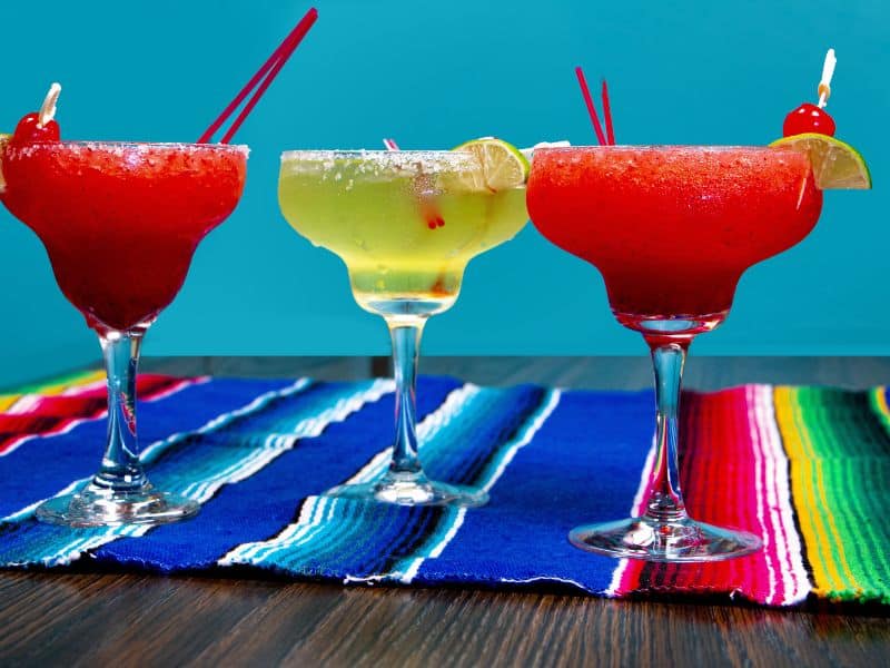 3 margaritas on a colorful placemat from Mexico