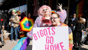 Pro- and anti-drag queen protesters rally outside a book store's Drag Queen Story Time in Royal Oak, Mich., on March 11, 2023.