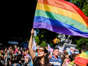 Woman holding up a gay pride flag. Mariana Nedelcu/SOPA Images/LightRocket via Getty Images