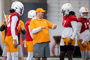 Tennessee head coach Josh Heupel, center, speaks with quarterback Joe Milton III (7) as quarterback Nico Iamaleava (12) stands to the left during spring football practice on Monday, March 20, 2023.