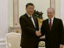 Russia: Vladimir Putin shakes hands with Xi Jinping